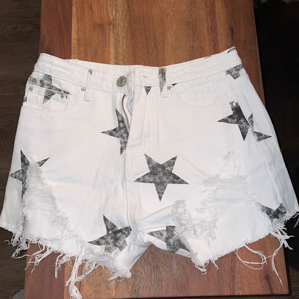 White jean shorts with black stars